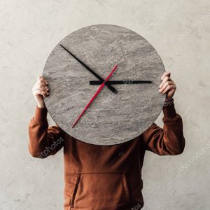 Person holding clock