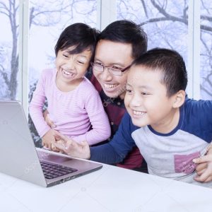Young father and kids having fun with laptop